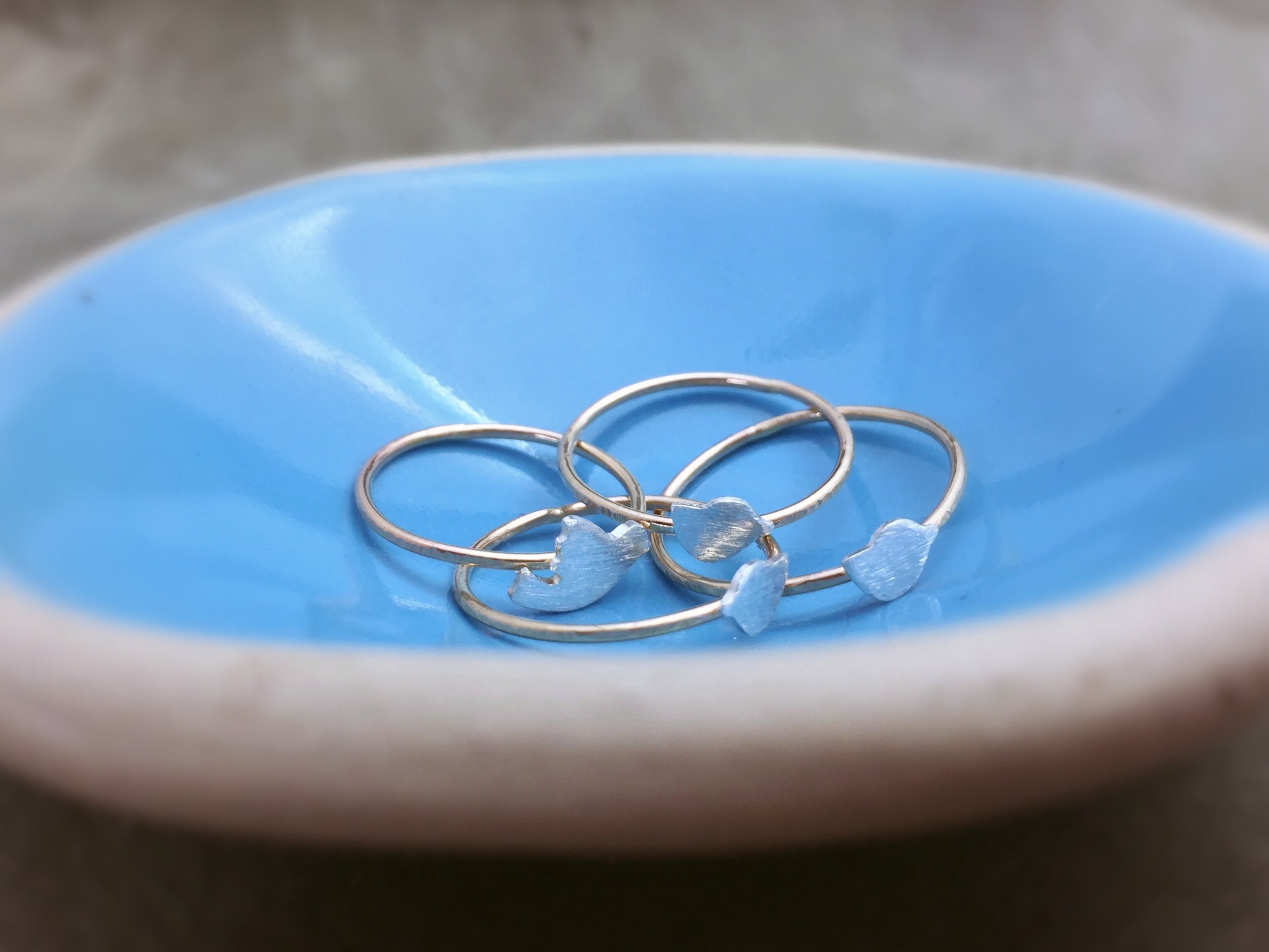 silver and gold rings with birds