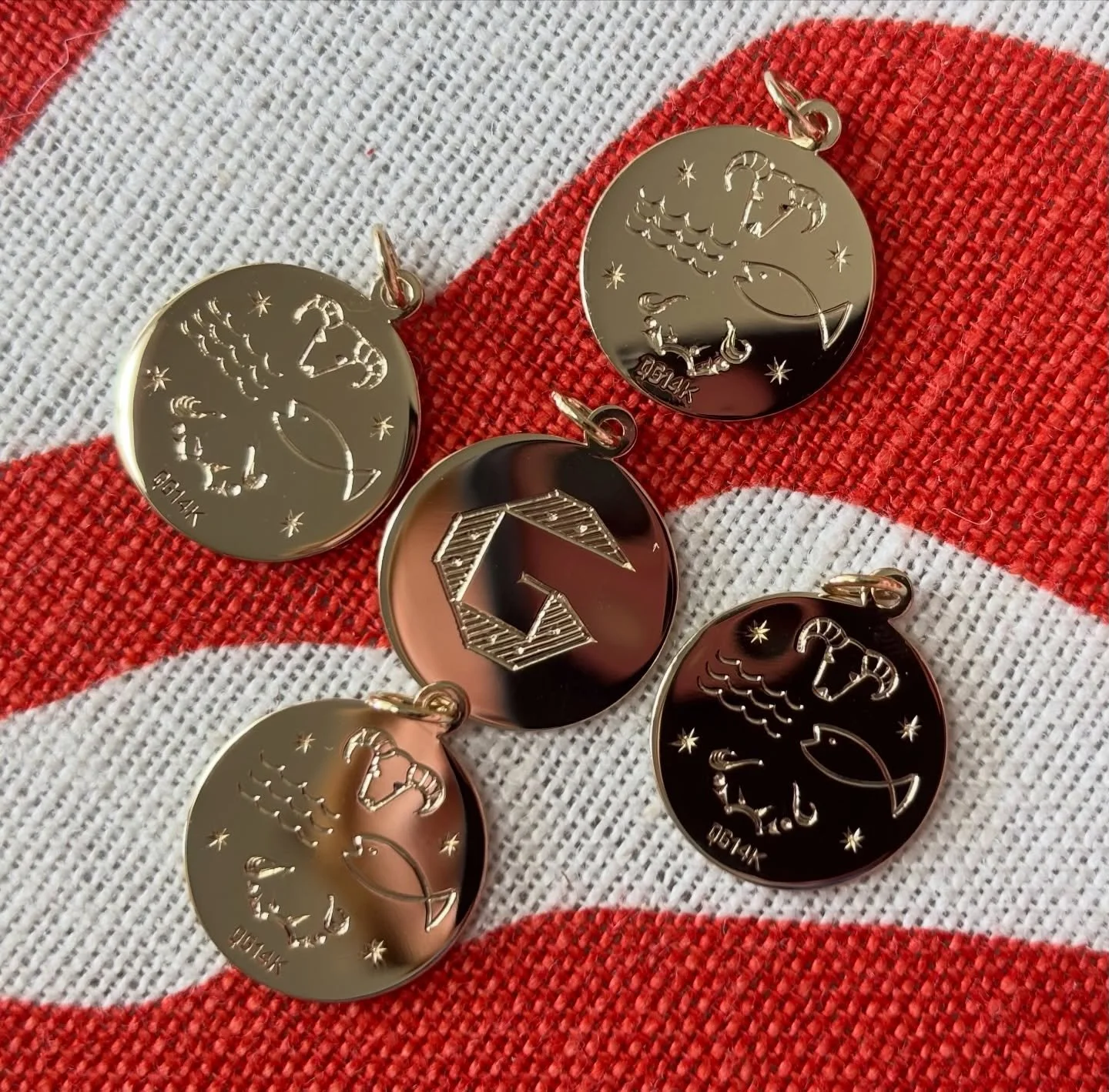 Fabulous family project - Five custom hand engraved solid gold discs for five family members- each with a matching custom initial on the front and a design incorporating the zodiac signs of the family in the back. Thank you to our lovely client for b