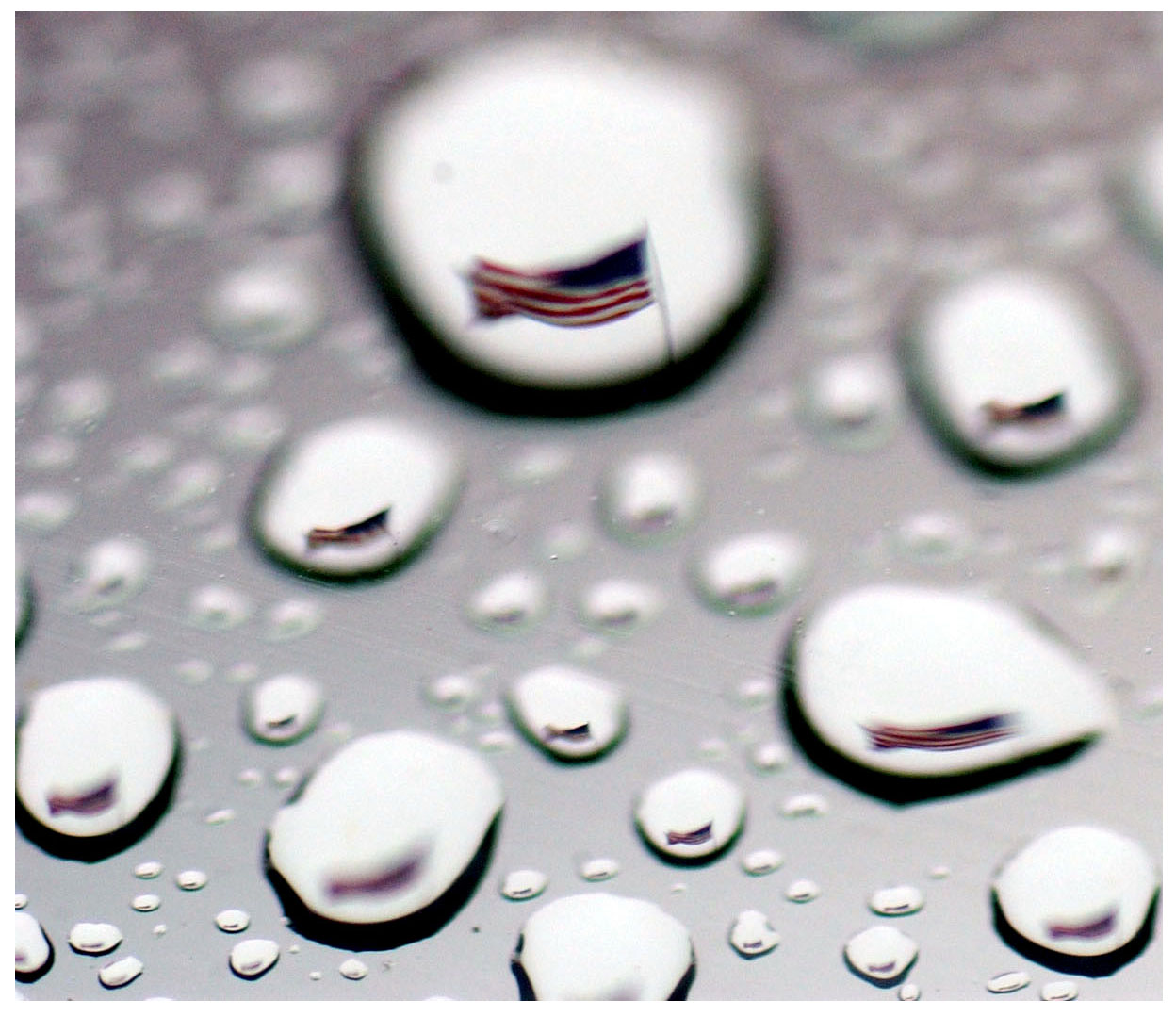 ron lewis/staff 4.3.06 san mateo county times
The American Flag is seen through a raindrop during showers in Redwood City Monday.