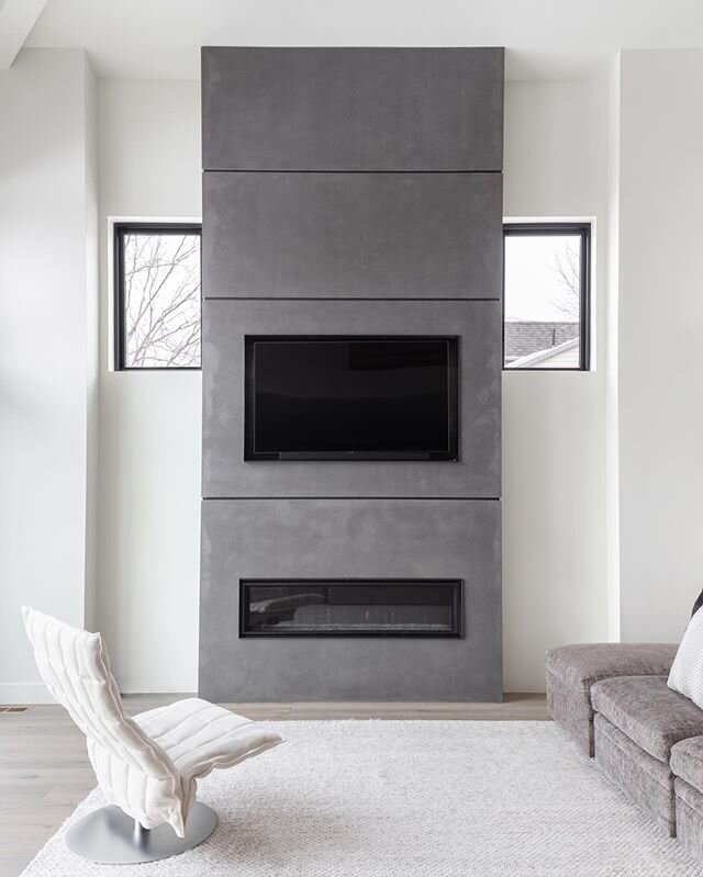 Tall and beautiful - this 15&rsquo; high fireplace keeps this space feeling open with its light color, but holds structure with a small steel reveal between panels. 
Scroll for some details. 
#concretepanels #customfireplace #fireplace #fireplacedesi