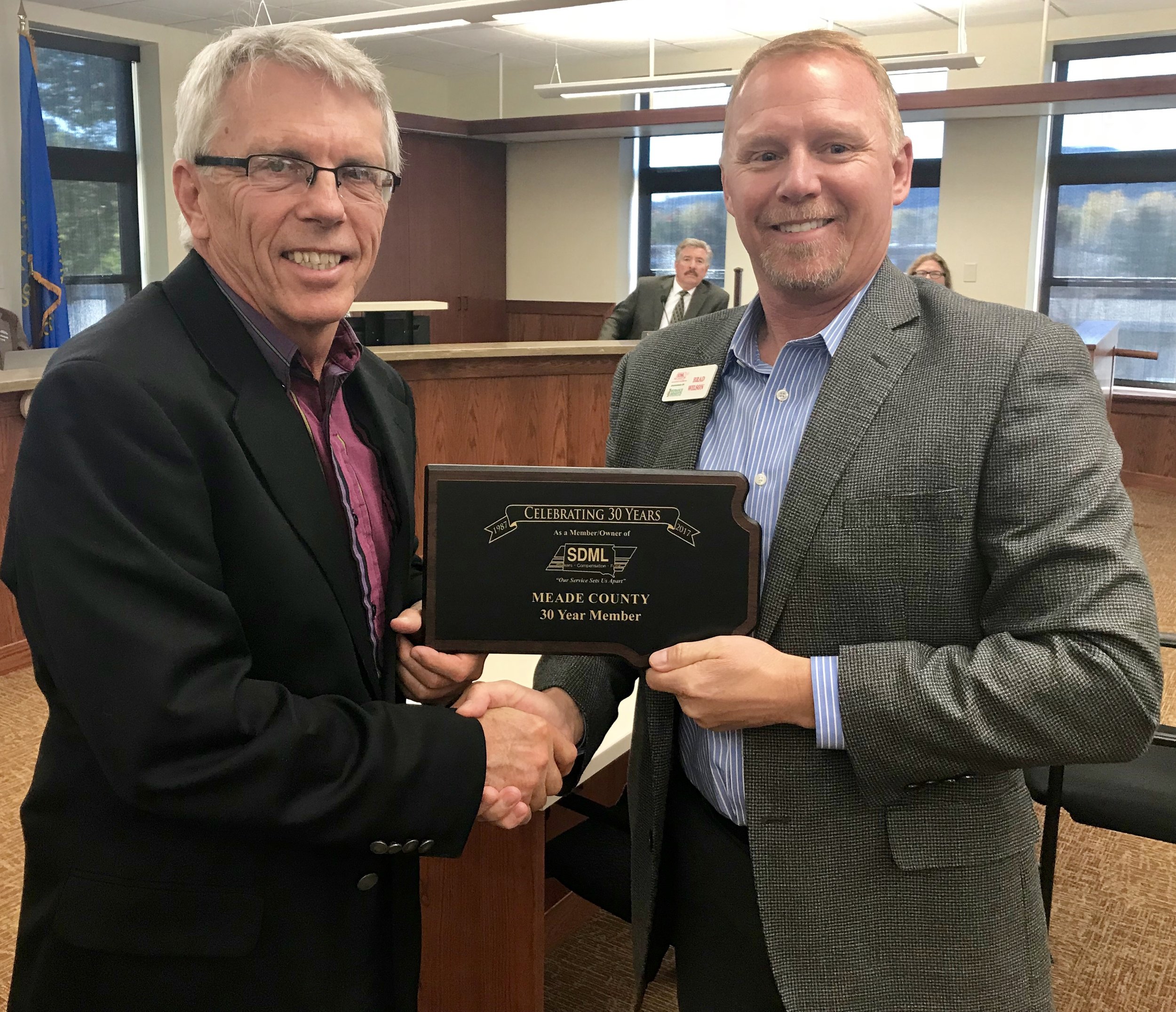 County Commission Chairman Galen Niederwerder is pictured above accepting a plaque from SDML Workers’ Compensation Fund Administrator, Brad Wilson.