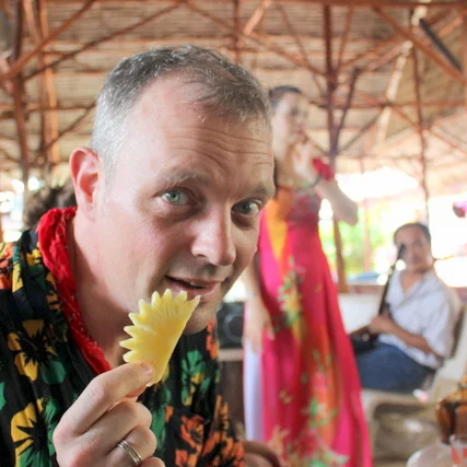 Eating fruit and enjoying local dancers in the Mekong Delta.
