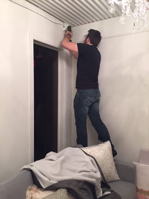Installing the drapery wall to balance out the wall behind the sofa 