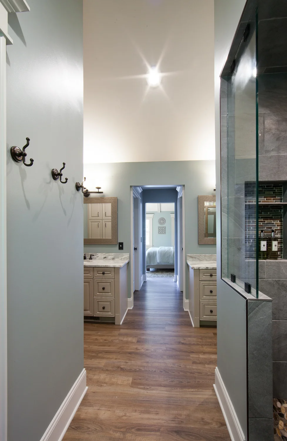 Dual vanities means the husband and wife each get their own side complete with their own private closets in the hallway which leads to the bedroom. 