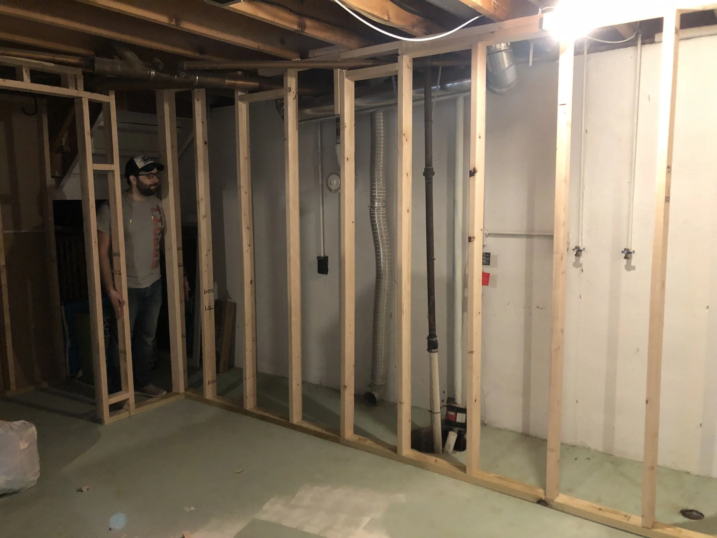 This is the washer and dryer wall. Because of the sump pump and the huge amount of piping on that wall for plumbing, drainage, and HVAC, we decided to frame it out and create a closet behind the washer and dryer so it can still be accessed, but it allowed us to have a clean, pipe free wall for the washer and dryer.