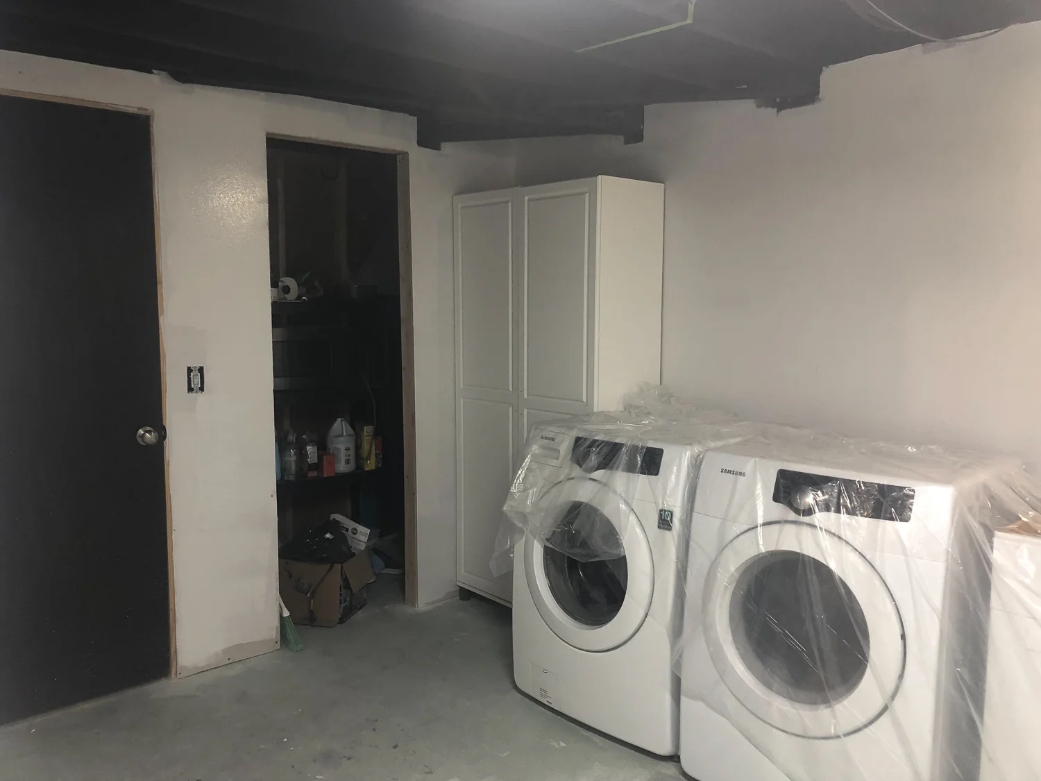 The door on the left is the entrance into the rest of our home. The door on the right is the entrance into the new closet we created that goes behind the washer and dryer to access the sump pump and drainage pipes.