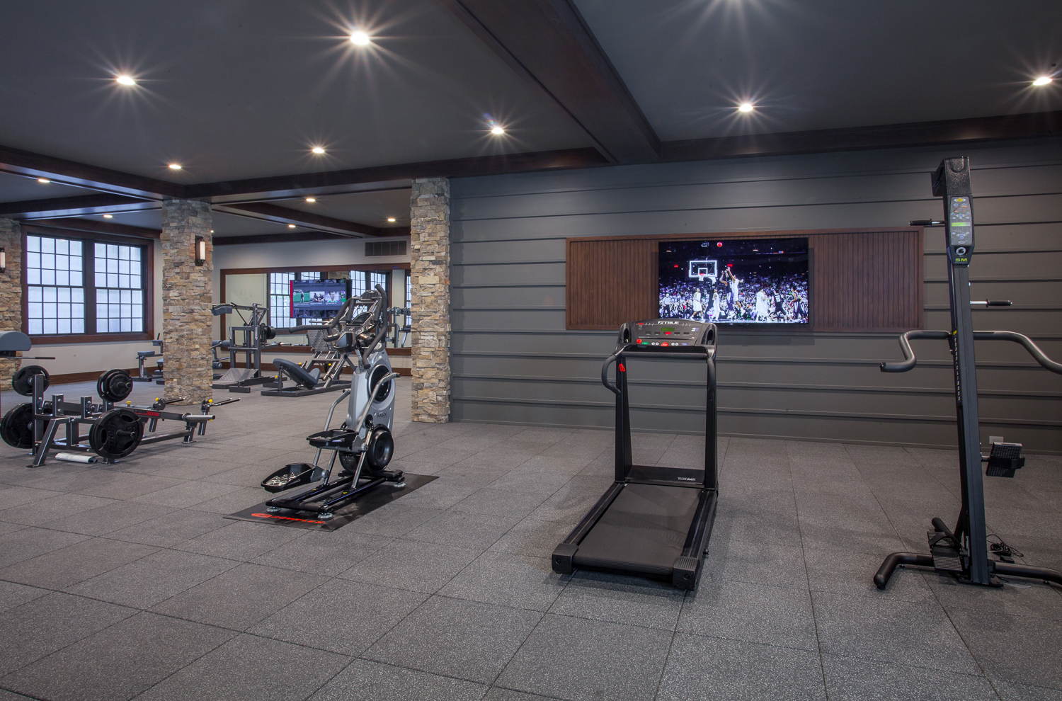 Kendall Charcoal works perfectly with any style. Shown here, it’s featured in a contemporary home gym on an accent wall and on the ceiling. Paired with it on the walls in the background? La Paloma Gray!