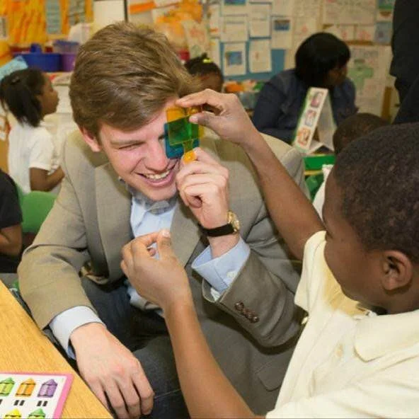 Matt "makes green" with a kindergartner at Atlanta's Cleveland Avenue Elementary School during a visit there in March 2014.