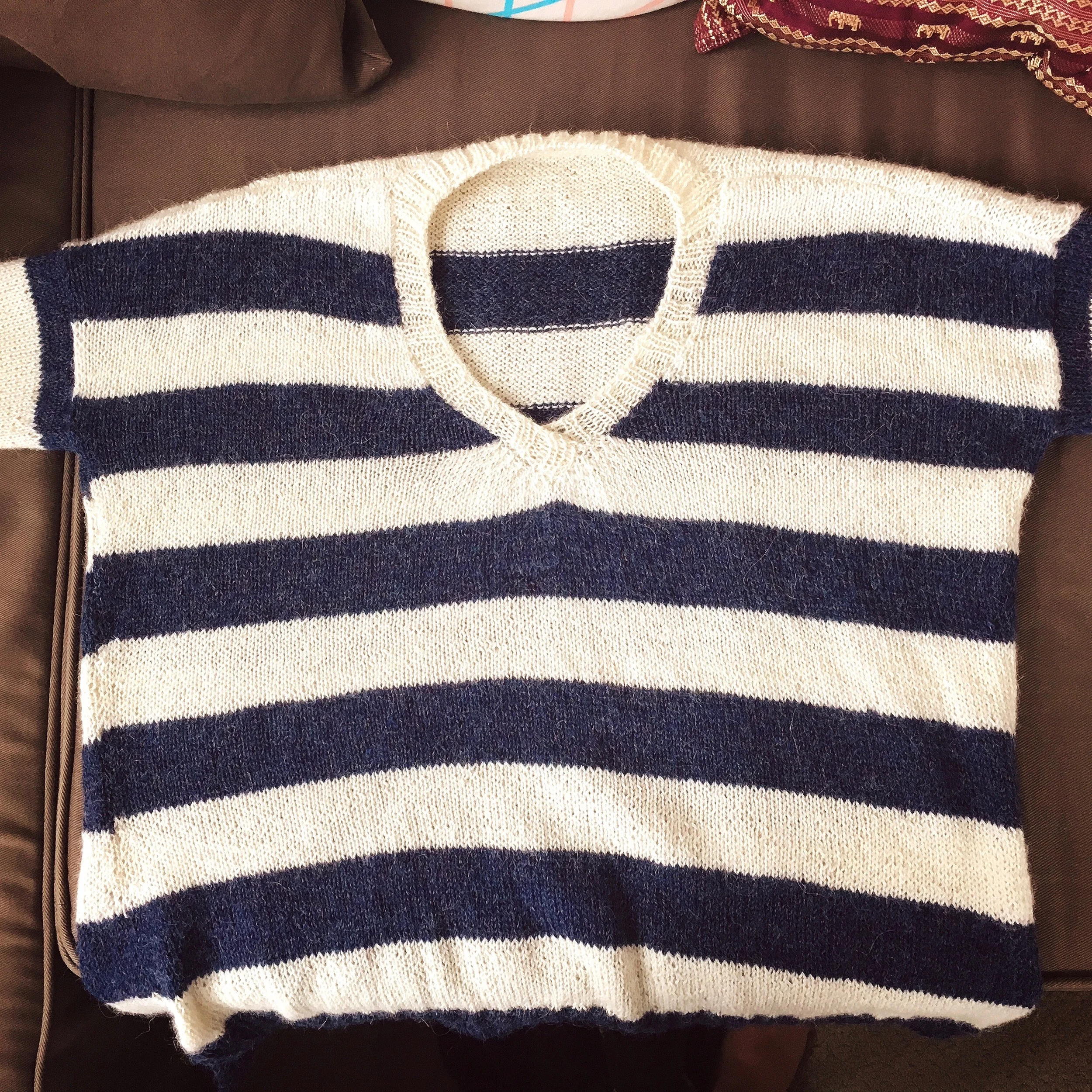 I really like the overlap at the neckline....it does require some steam blocking to get it to sit flat after adding the neckline, keep that in mind if you attempt this pattern