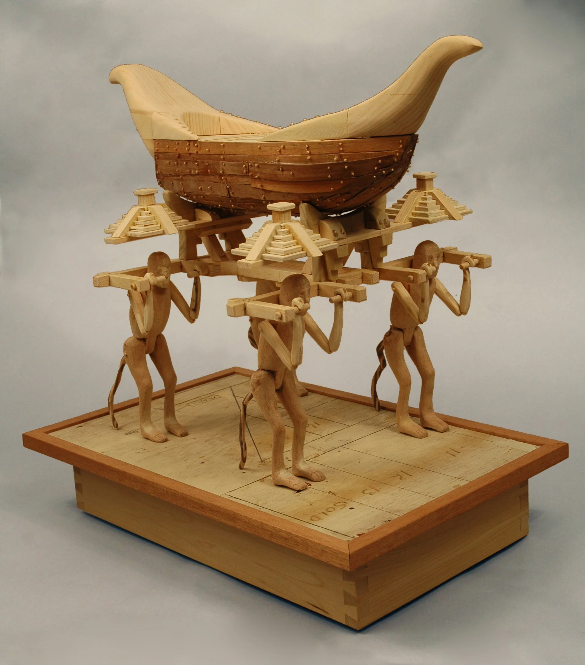 19. Title: The Antediluvian Plan of the Manikin Men (from the Popol Vuh) Medium: Wood and paint Dimensions: 25"h x 33"w x "d