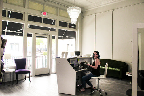 a picture of a person inside of a salon at the reception desk