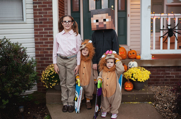 children in their halloween costumes posing together 