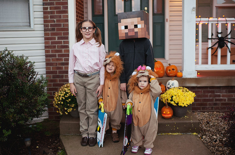 children in their halloween costumes posing together