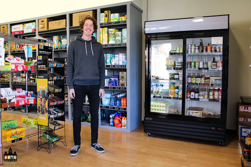 a picture of a man inside a grocery store