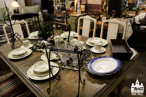 a picture on the inside of the vintage shop with some dining and plate wear 