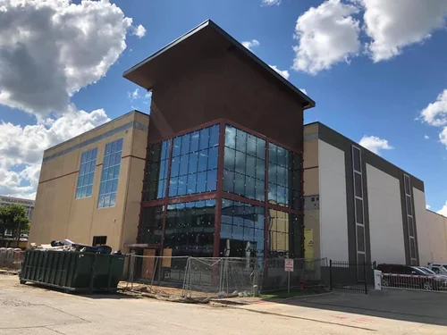 NCTC building in downtown Denton under construction with a dumpster in front of it 