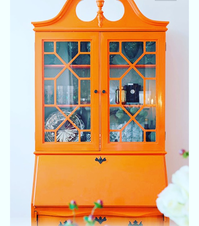 Painted orange display cabinet. Image from Pinterest.