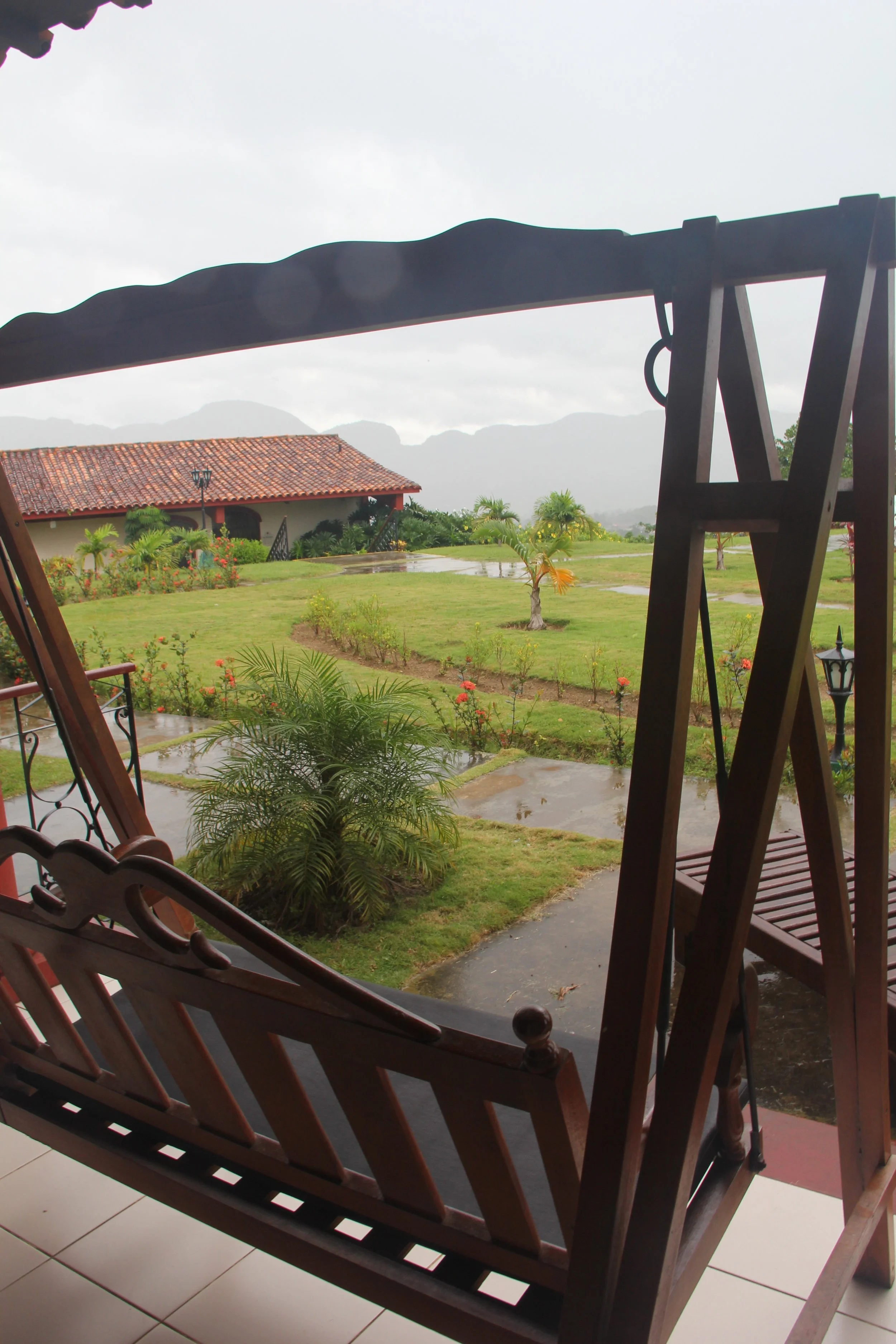 Every room at the hotel in Viñales is equipped with a porch and a rocking chair to enjoy the mountain views. To the left is the restaurant with its commanding views.