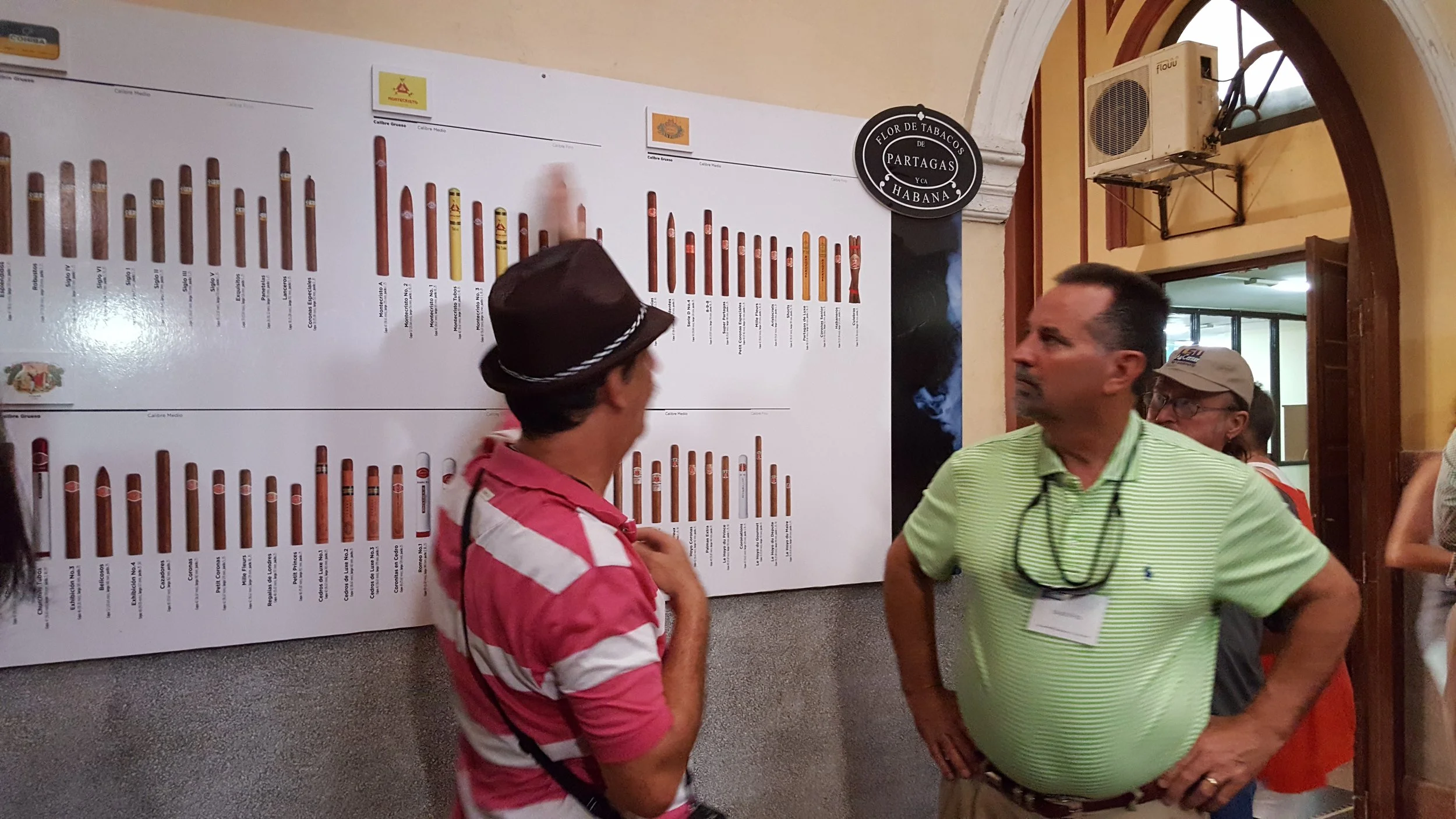 Our tour guide explains the various types of cigars at the Viviero Alamar cigar factory to Ed Reeves.