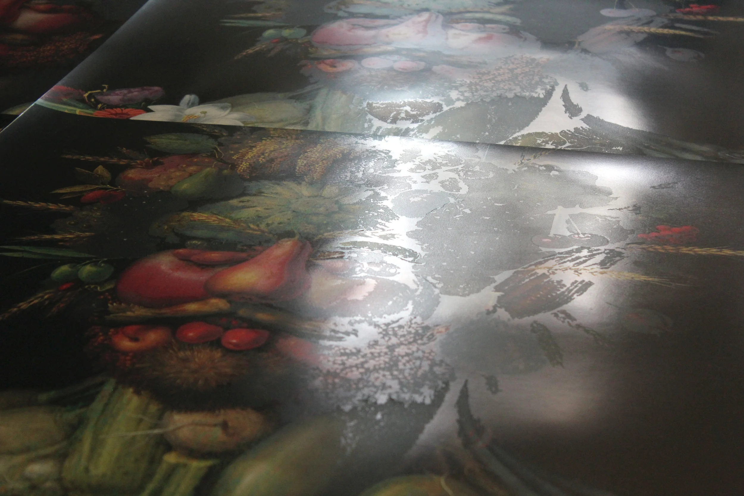 Glare exposing the otherwise transparent ink overlays.