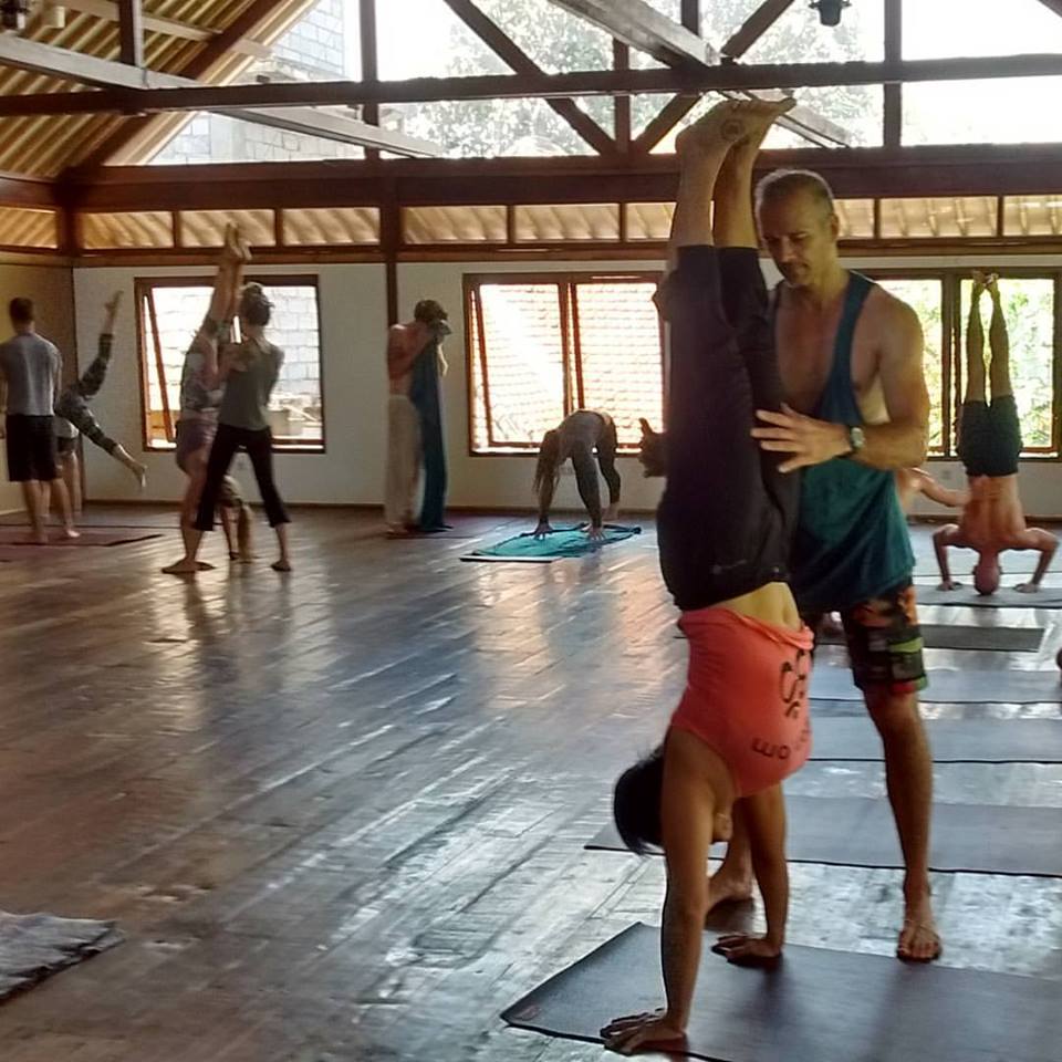 Hang practicing her handstand in an arm balancing class at Radiantly Alive Yoga Studio in Ubud, Bali. 