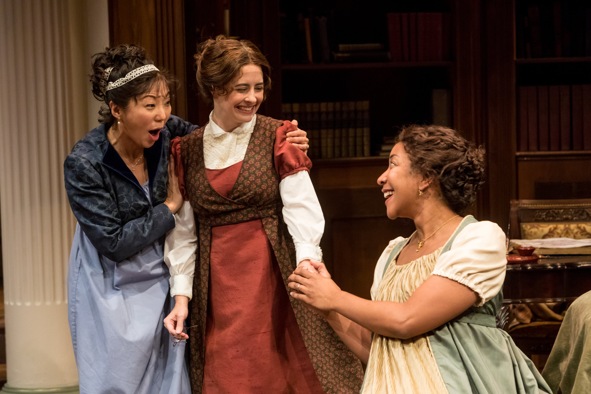 3 women in period clothing laughing