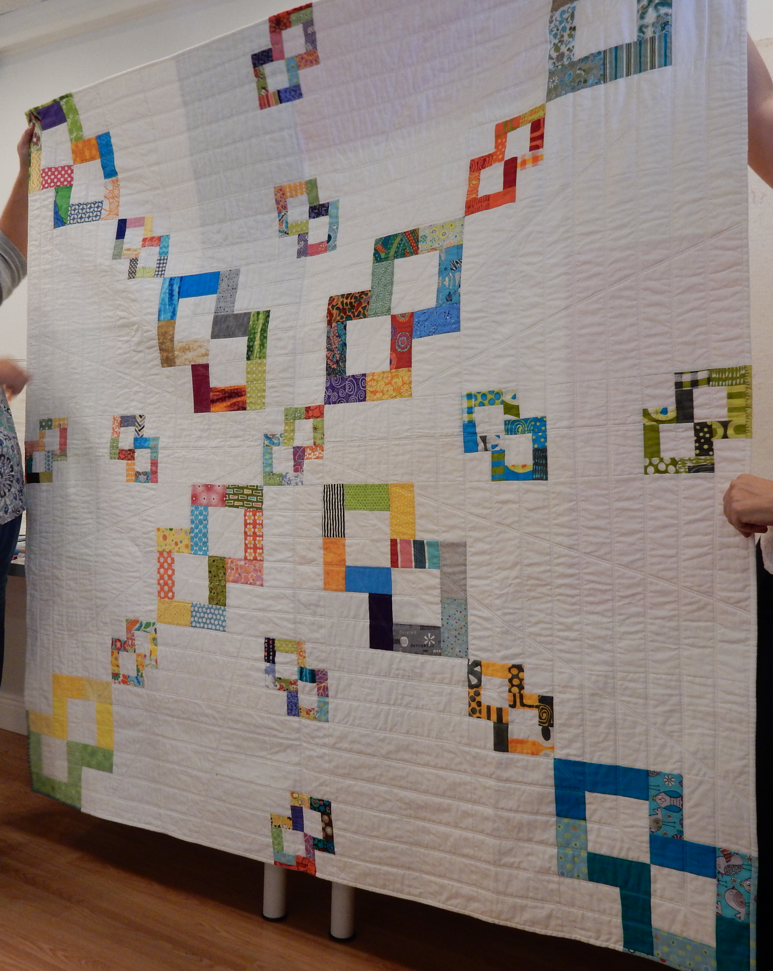 Charlotte Noll showed an example of a modern quilt with negative space, using her SFMQG bee blocks.