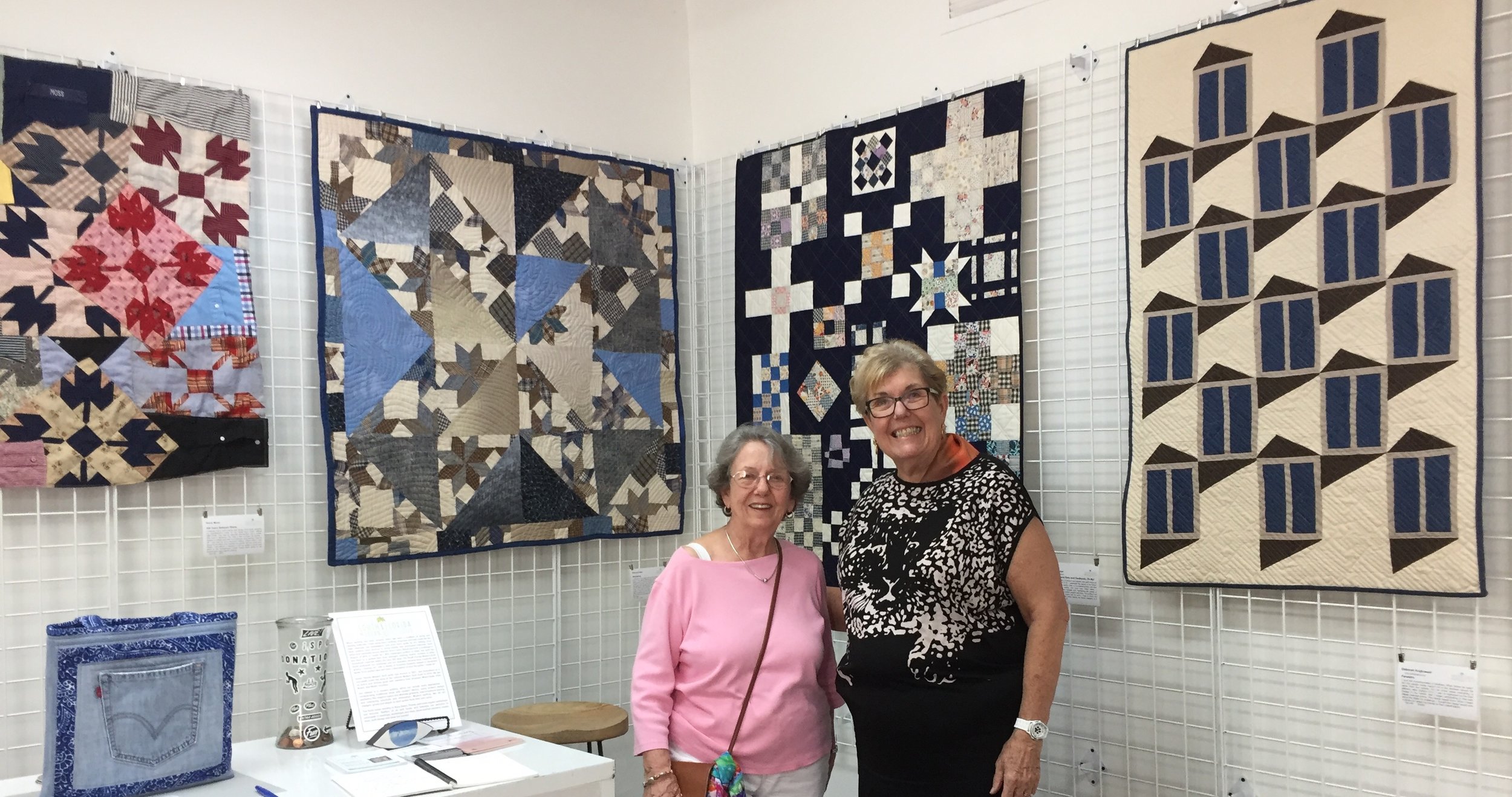  Artist Diane Moss (on right) and Guest   100 Years Between Shirts  by Diane Moss   Wondering  by Patricia Auten   Nine Patch and Navy and Feedsacks, Oh My!  by Nicole Kaplan   Fenestra  by Deborah Krajkowski   Levi Pockets Tote  by Pam Chamberlin 
