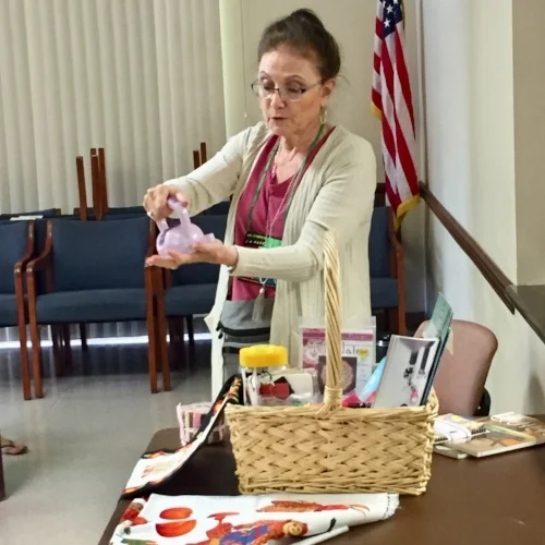  Judy showing off the Sew-Tastic Basket contents. Abbie won it this month. 