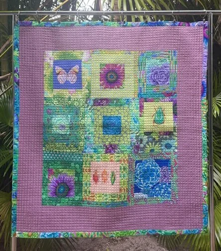 S&T KellyK - A Little Garden - This quilt was commissioned for someone preparing to welcome a new baby. The request was for bold colors, garden crops, and plenty of beneficial insects.