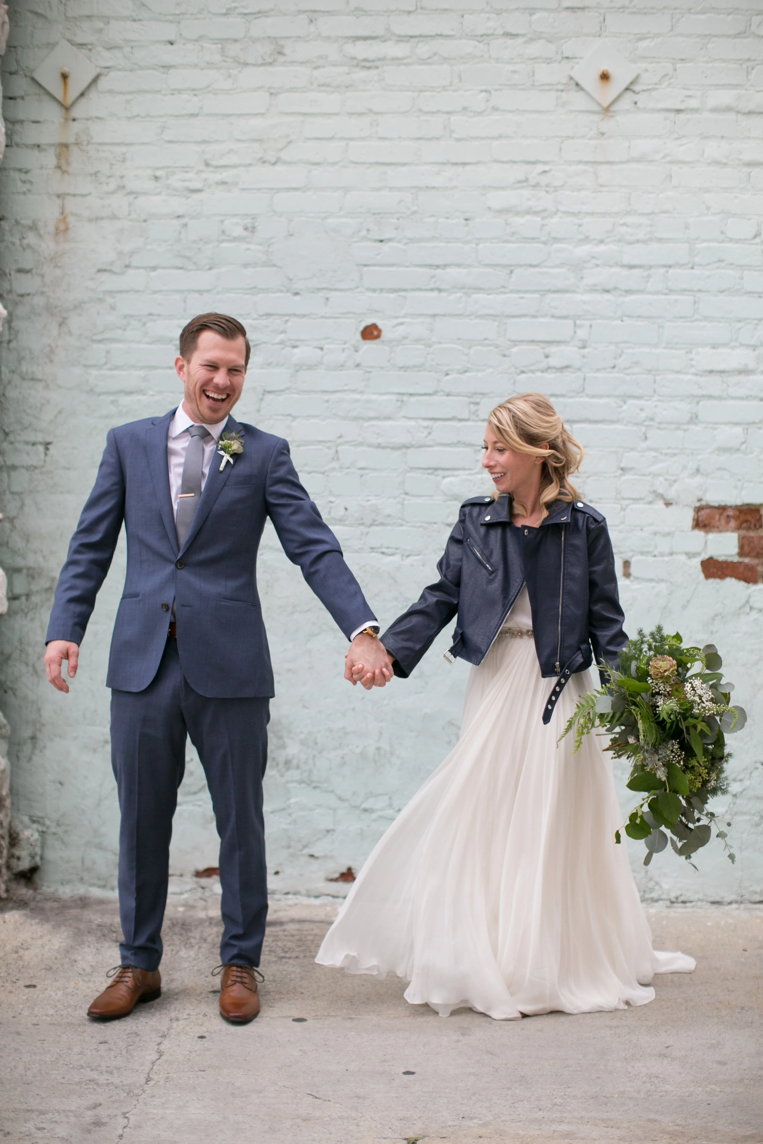 Bride and groom had a stunning navy and green winter wedding at The Loft On Pine in Long Beach, CA. The pops of rich colors matched the venues industrial vibe and the bride's giant bouquet of wild greens was pretty epic. The flowy BHLDN two piece paired with a leather jacket was perfect for the cooler weather but also looked pretty badass. Planning:@janealexandraevents Venue:@theloftonpine #JAE #longbeachweddingvenue #weddingplanning #theloftonpine #winterweddingideas