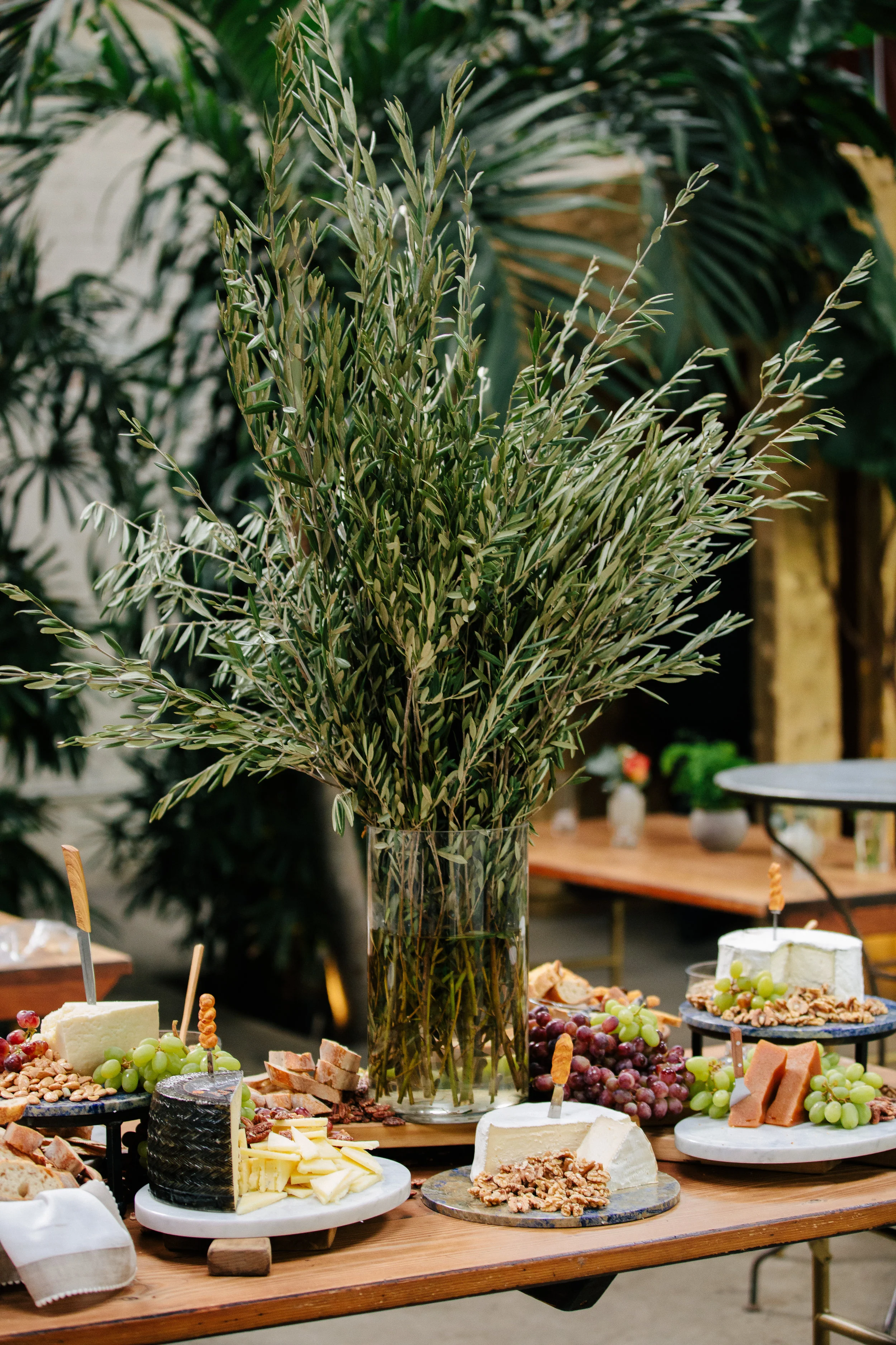 This DTLA wedding was inspired by Earth Day, it’s vibe was natural and minimal. The color palate is blue, green, rusty pinks and oranges. The LA bride had a custom wedding gown that was simply elegant. Rental furniture with velvet, wood matched the industrial #greenhouse of Millwick Wedding Venue in Los Angeles, CA. The florals were potted plants so they could be replanted post wedding. #JAE #janealexandraevents #dtlaweddingvenue #weddingplanning #losangeleswedding