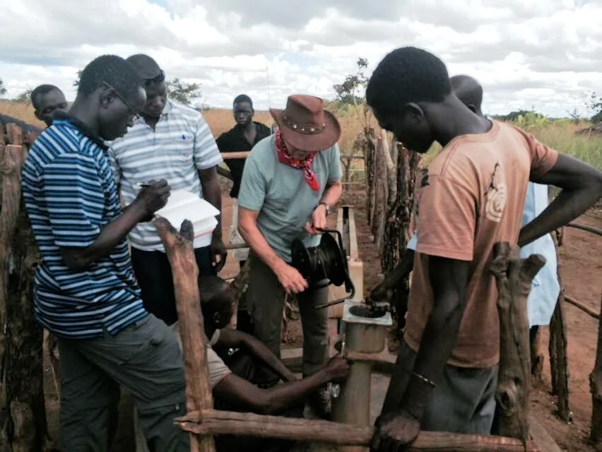 Deployinging the In-Situ transducer into the Palabek water well.