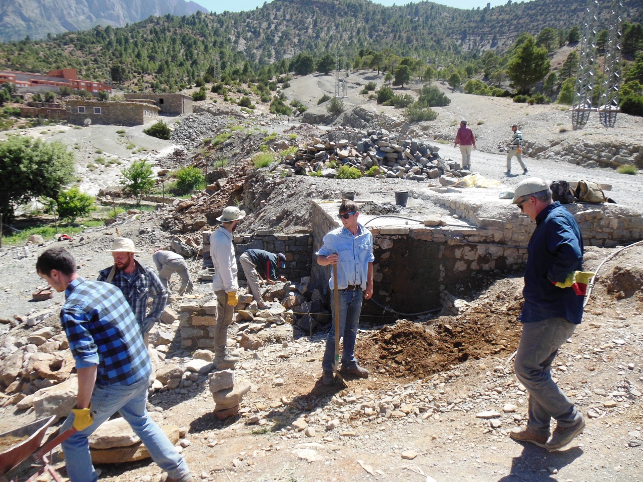 Professor Chris Livingston (right) directing his students in construction of the water fountain at the Amezray water chateau.