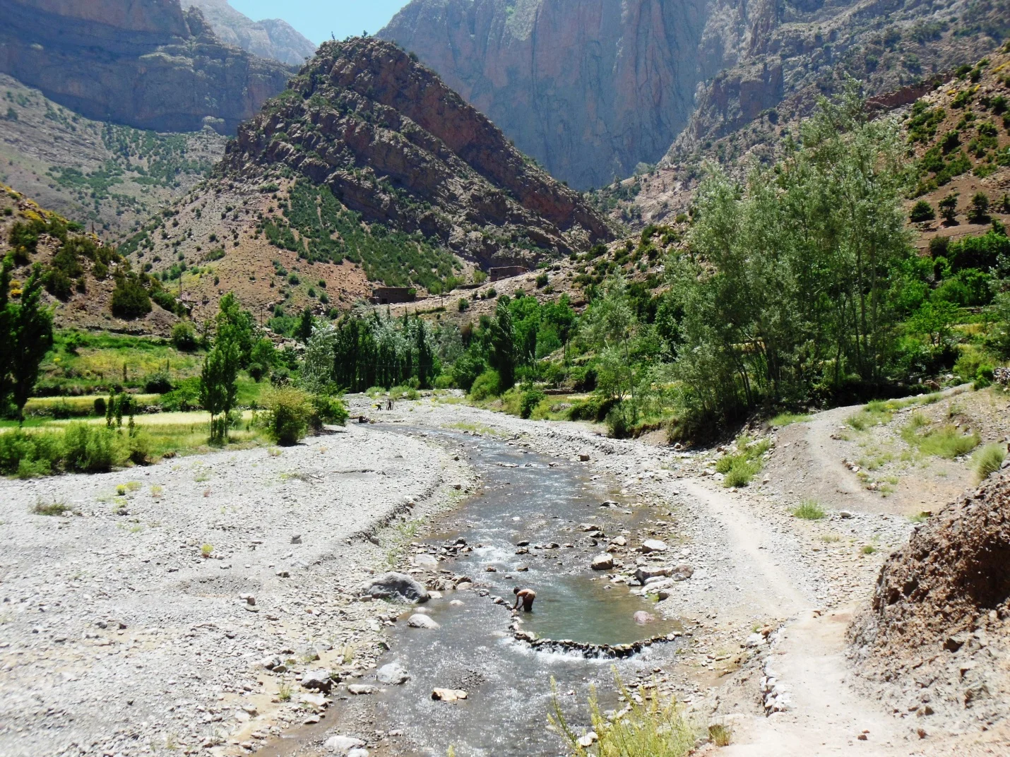 A boy setting irrigation dam in river downstream of Taghia.