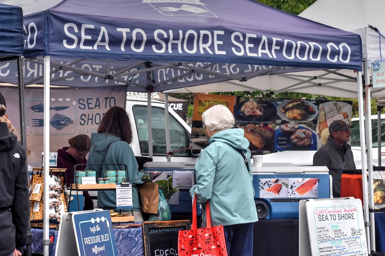 Shoppers at the Sea to Shore Seafood Co. tent at the Everett Farmers Market