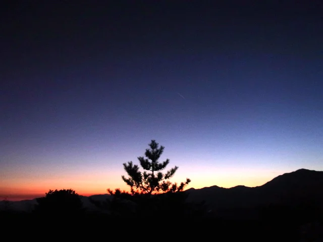  The sky turns deep blue as the dim afterglow fades away 