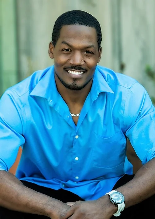 TC IN BLUE SHIRT.jpg