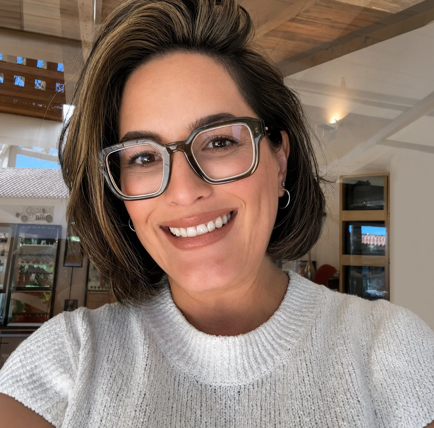 Profile picture of a Stacy, smiling while wearing glasses.