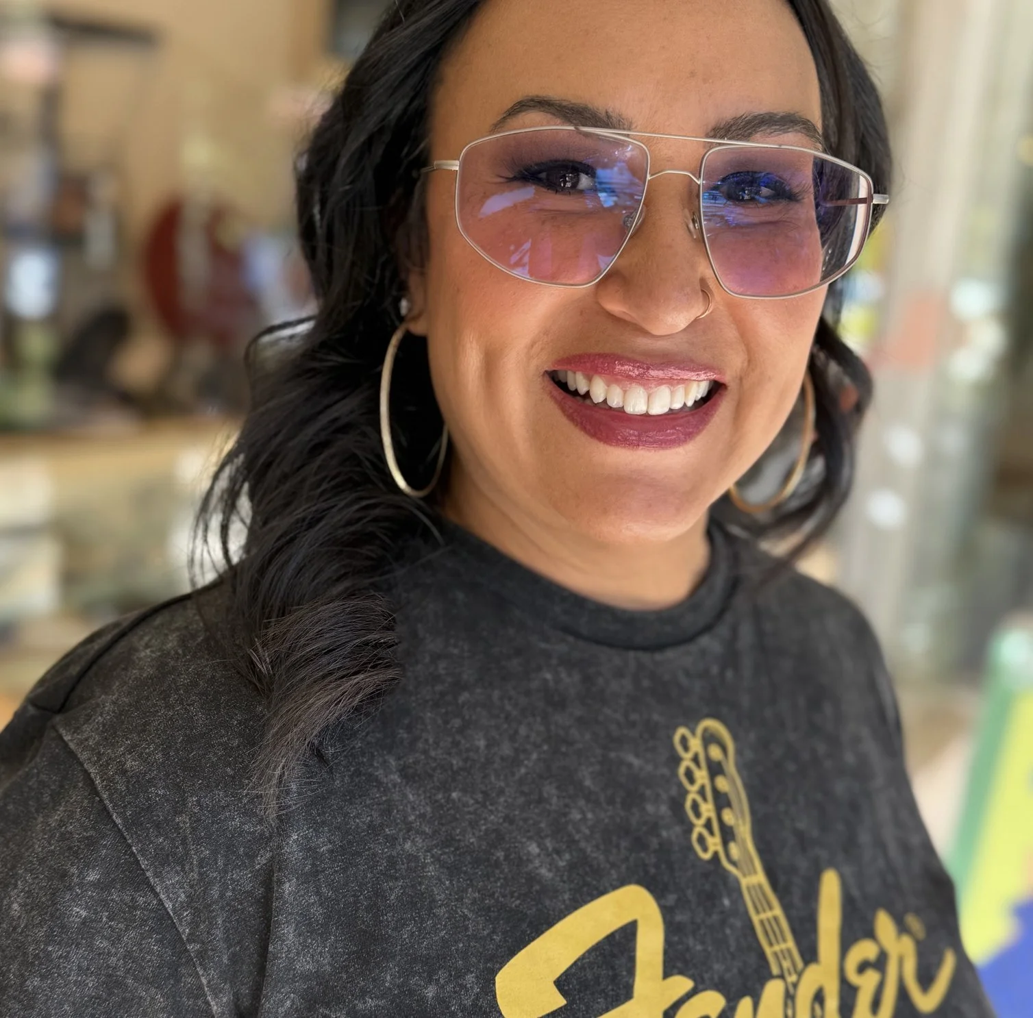 Emily, smiling in sunglasses