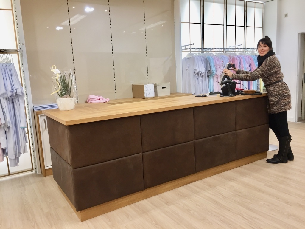 This cash counter has been custom designed. and handcrafted from natural Austrian oak wood. Front is covered with pure vegetable tanned buffalo leather on coffered system. Pictured during pre-opening. Backfront shelving will be re-designed and is still pending. Design: Ralph Budwell - www.budwell-creations.com