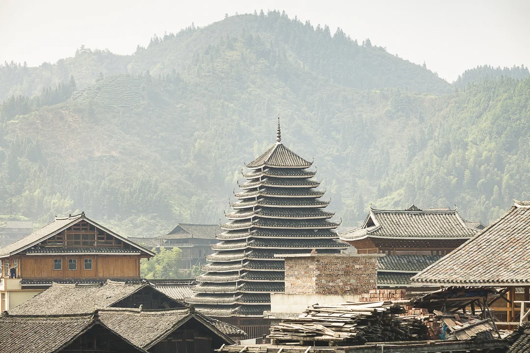 Buildings and workers in Linxi, Sanjiang County, Guangxi, China.
