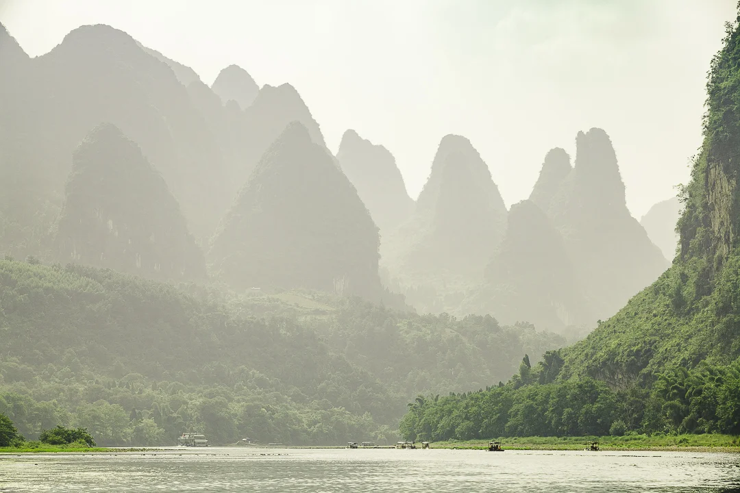 Exploring Lí Jiãng (Li river) in a bamboo raft surrounded by awesome karst peaks.