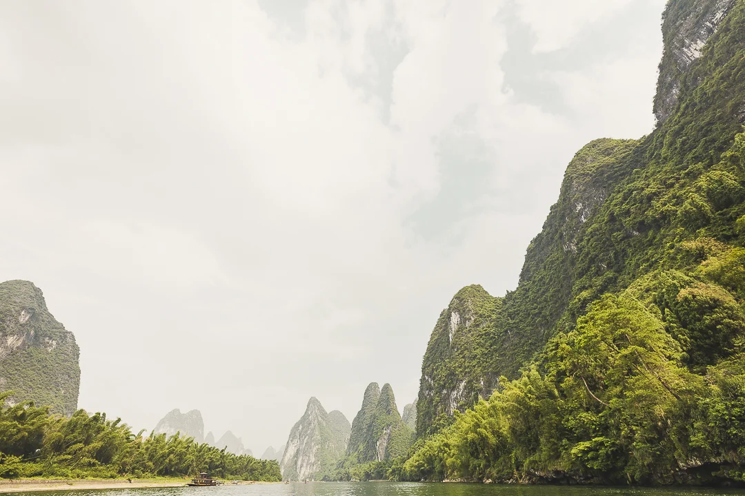 Exploring Lí Jiãng (Li river) in a bamboo raft surrounded by awesome karst peaks.