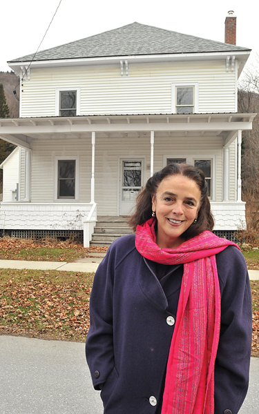 ELIZABETH READY, DIRECTOR of the John Graham Emergency Shelter in Vergennes, stands in front of a multi-family Bristol home the agency has acquired to use as transitional housing for people moving out of the shelter. Independent photo/Trent CampbelL