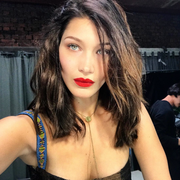 Bella Hadid goes TOPLESS behind massive LV bag for brand campaign