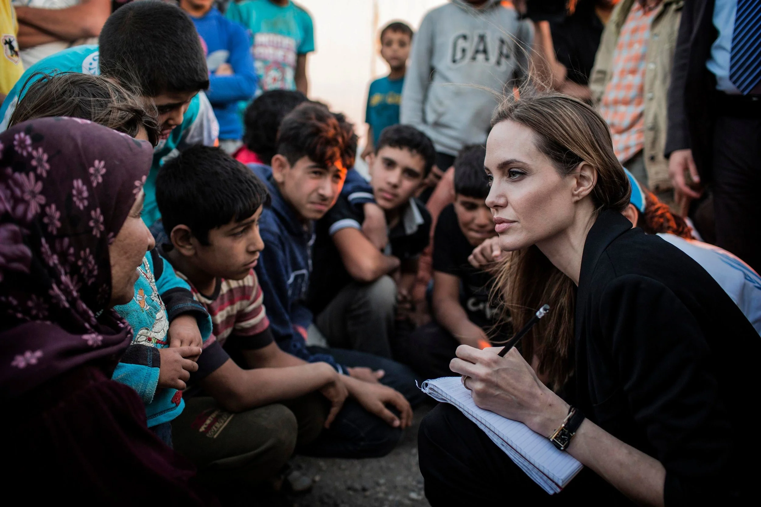 Angelina Jolie taking notes in a Syrian refugee camp in Jordan, February 2017. 