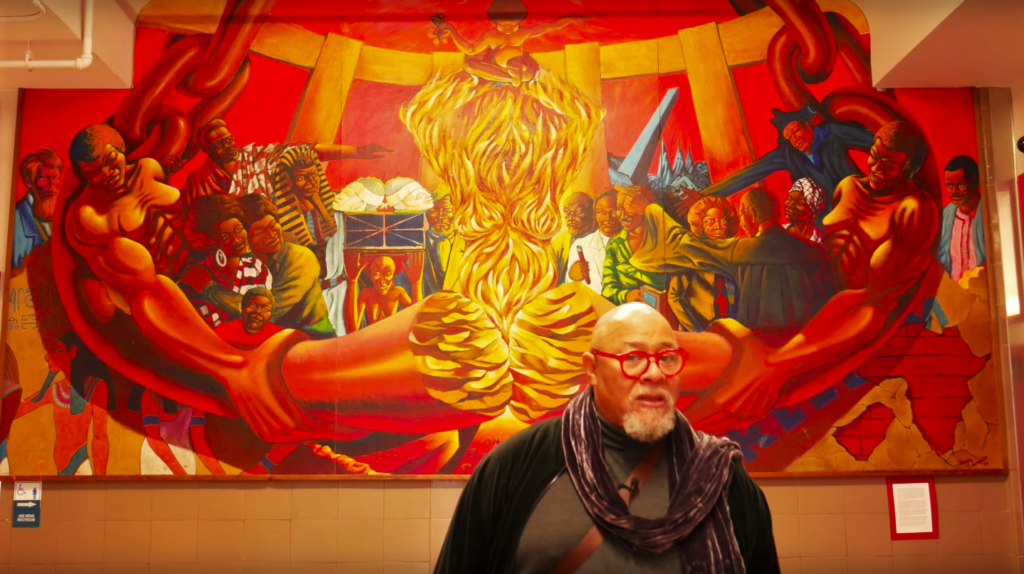 Dewey Crumpler’s in front of the African American panel of Multi-Ethnic Heritage at George Washington High School.