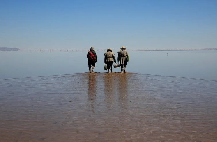 Poor countries have borne the brunt of global climate change. Here, indigenous Urus Muratos men walk on the dried-out Lake Poopo, once Bolivia’s second-largest water body. Reuters/David Mercado