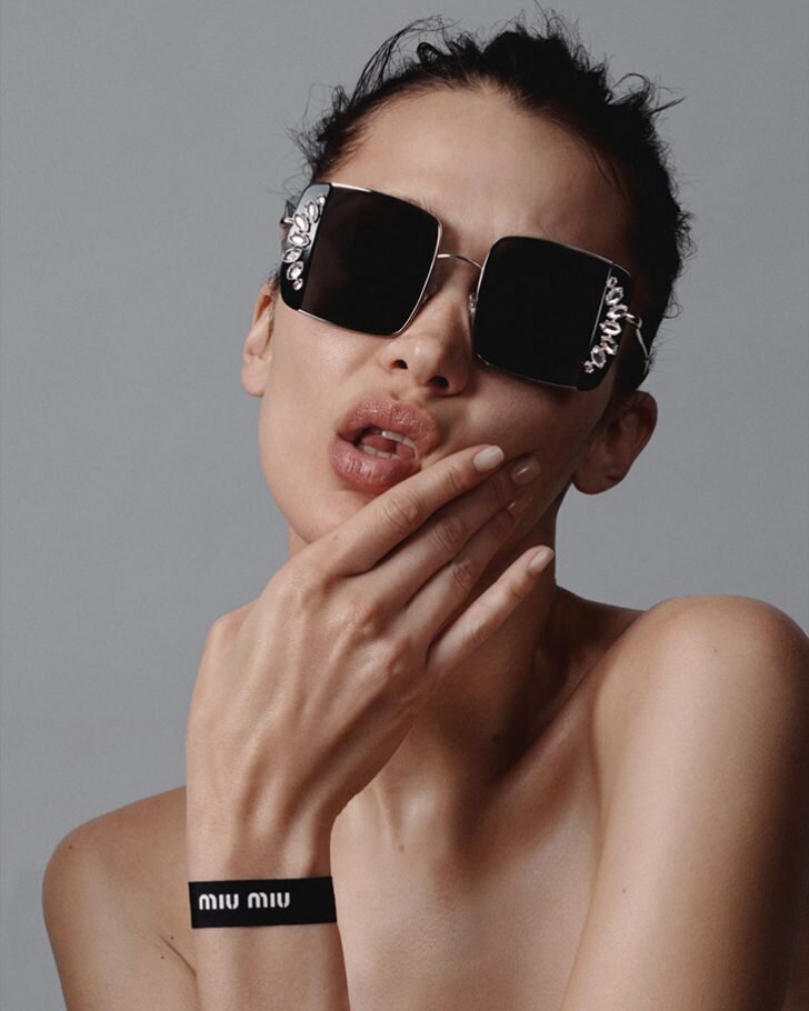  Bella Hadid wears Miu Miu Noir sunglasses lensed by Liz Collins. 